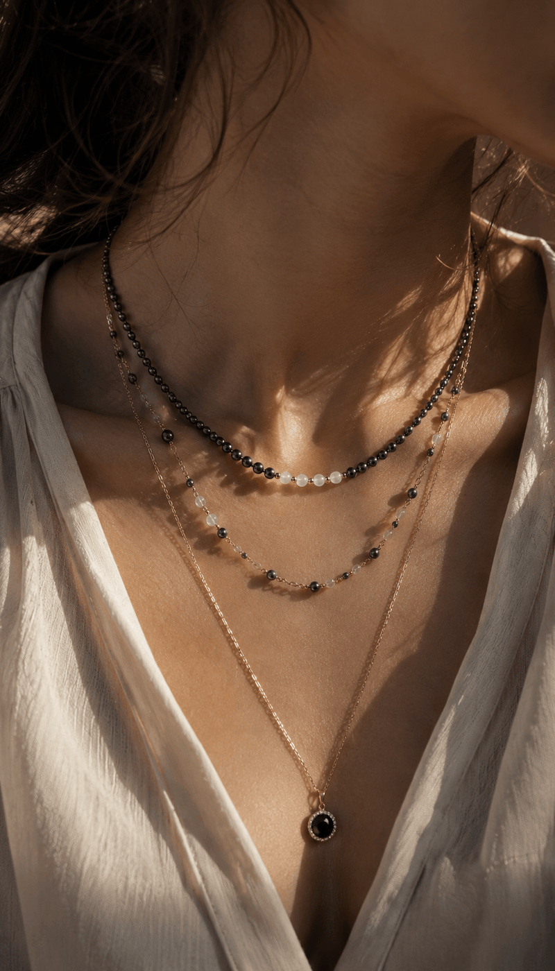 Close-up of a layered beaded necklace on bare shoulders